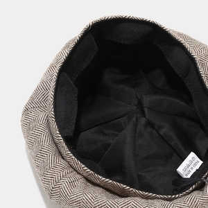 Detail of herringbone tweed fabric with internal lining and wash care label