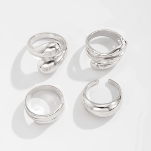 Detailed view of silver minimalist ring set with irregular liquid metal textures