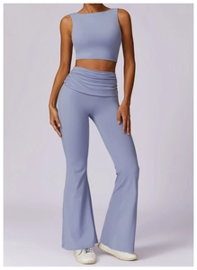 Detail of high-waisted flared yoga leggings with elegant crossover waist pleat design
