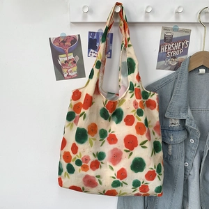 Detail of floral canvas tote bag hanging indoors with vintage aesthetic background