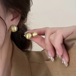 Minimalist matte gold round stud earrings with brushed texture in two distinct sizes