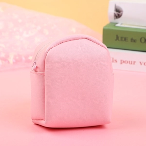 Detailed macro view of pink mini backpack coin purse with textured lychee grain leather