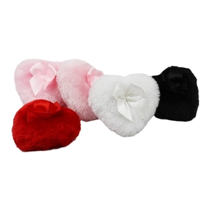 Set of five plush heart-shaped powder puffs in various colors with ribbon bows