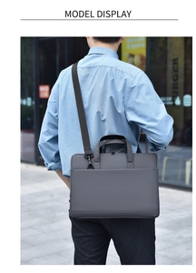 Slim 16-inch dark grey waterproof laptop bag worn with adjustable shoulder strap