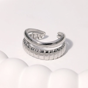 Detail of silver double-layered open ring featuring smooth and ribbed textured finishes