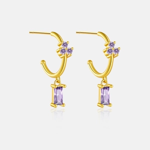 Detailed macro view of S925 silver gold-plated C-shaped earrings with purple zircon