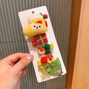 Close-up of a 6-piece Christmas hair clip set with plush reindeer and tree designs