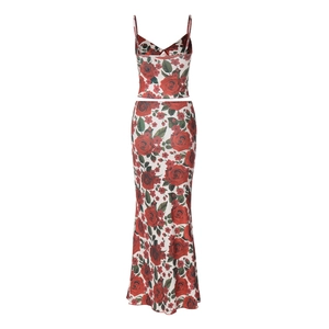 Detailed view of the red floral print on the white V-neck strap top and maxi skirt set