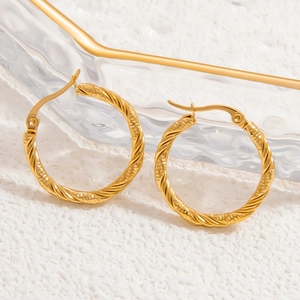 Detailed macro view of 18k gold plated stainless steel twisted hoop earring texture