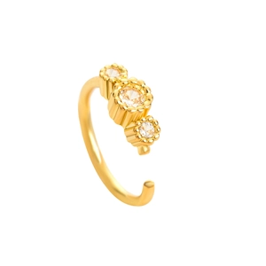 Detail of gold nose ring featuring three sparkling cubic zirconia in a minimalist design