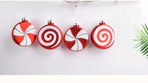 Detail of four red and white candy cane striped Christmas ball ornaments on a branch