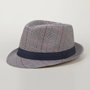 Close-up of British style fedora hat featuring grey plaid fabric and navy ribbon band