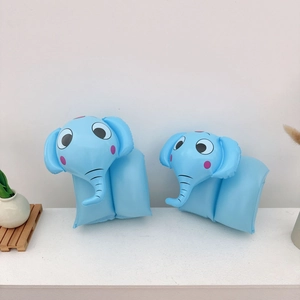 Detailed close-up of light blue inflatable arm floats with cute cartoon elephant design