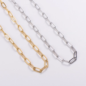 Gold and silver stainless steel paperclip necklaces in a minimalist stacked fashion look