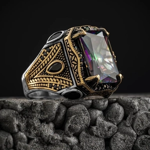 Vintage men's ring featuring a rainbow gemstone and ornate gold and silver snake band