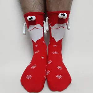 Detail of red Christmas socks with magnetic hands and 3D Santa Claus 3D features