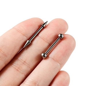 G23 titanium barbell body jewelry with cone and ball ends displayed on a finger