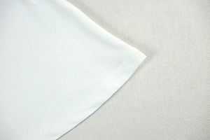 Detailed close-up of double-needle stitching on white backless dress hemline