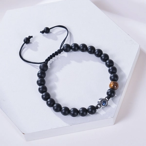 Matte bead projection stone bracelet with tiger eye stone on white platform