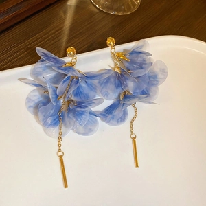 Elegant bohemian blue fabric flower tassel earrings on white ceramic tray display