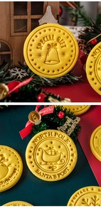 Close-up of yellow round Christmas cookie stamp featuring embossed Santa sleigh design