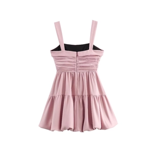 Back view of pink mini balloon dress with thin straps and ruffled details on white background