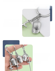 Zinc alloy fencing keychain detail showing metallic mask and foil charms with silver finish