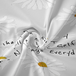 Detailed view of bohemian floral tapestry fabric with daisy prints and cursive text