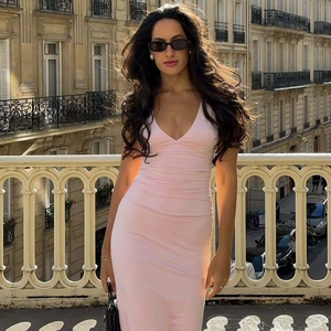 Close-up of slim fit pink maxi dress with v-neck and pleated detail on outdoor street
