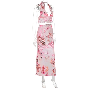 Detail of floral halter crop top and matching high waist maxi skirt for summer vacations