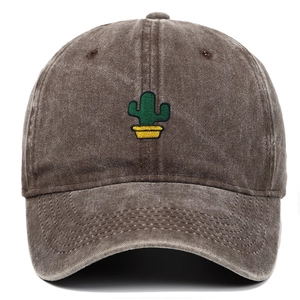 Close-up of green cactus embroidery on a vintage washed dark grey cotton baseball cap