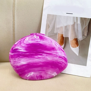 Detailed close-up of purple marble texture resin clutch bag on soft leather background