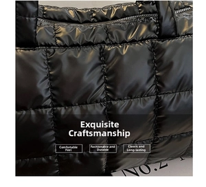 Close-up of black quilted puffer tote bag fabric showing detailed stitching and glossy texture