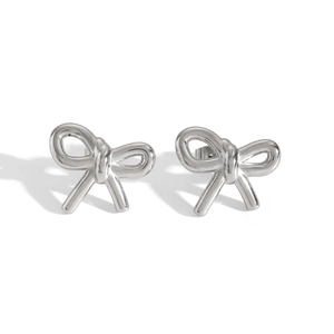 Detail showing elegant silver bow stud earrings in polished stainless steel