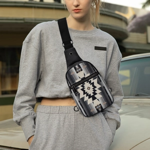 Detailed close-up of bohemian geometric canvas chest bag with multiple zipper compartments