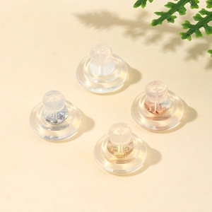 Detailed view of silicone and 18K gold butterfly earring backs in multiple metal finishes