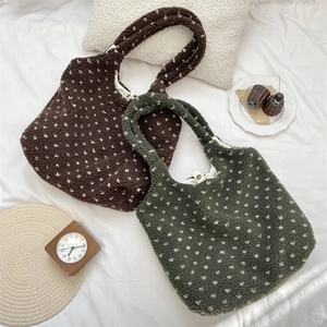 Detailed texture of fuzzy lamb wool tote bags in dark brown and forest green colors
