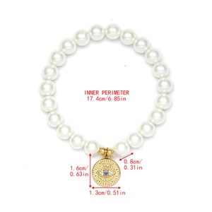 Detail view of pearl bracelet with evil eye charm showing inner perimeter 17.4cm size specs