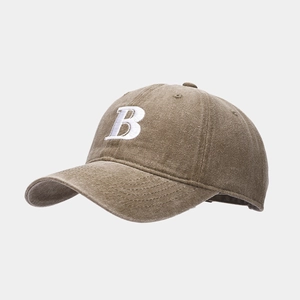 Close-up of brown cotton baseball cap with white embroidered letter B and curved brim