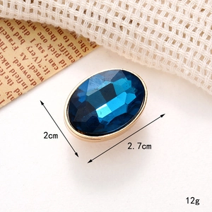 Detail view of blue oval gemstone shoe charm with dimensions 2.7x2cm and gold frame