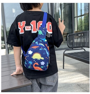 Rear view of a child wearing a blue dinosaur print chest bag for sizing and fit reference