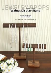 Detail of walnut wood T-bar jewelry stands for elegant necklace and bracelet display