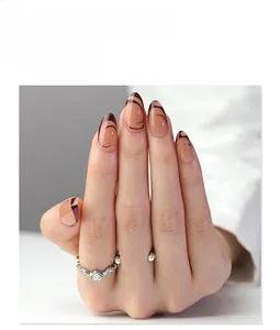 Detail view of almond press-on nails featuring nude base and dark brown abstract stripes