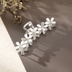 Elegant silver hair claw clip with white flower petals and sparkling rhinestones