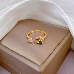 Gold open ring with colorful zircon flower and star on champagne jewelry box