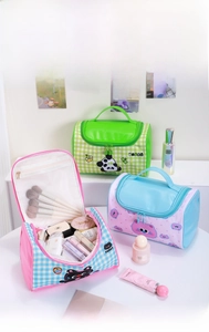 Detailed view of checkered cat and panda cosmetic bags with mesh pockets and top handles