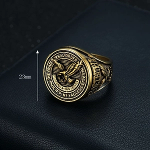 Gold eagle ring for Fraternal Order of Eagles with 23mm band on leather background