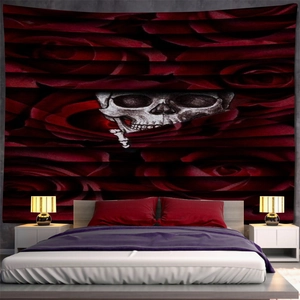 Gothic wall tapestry featuring a skull and red roses displayed over a bedroom headboard