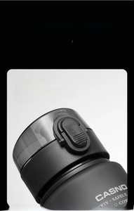 Close-up of matte black water bottle featuring a secure safety lock and leak-proof lid