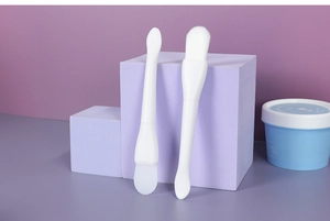 Close-up of double-headed facial mask brush set with silicone spatula and soft fiber bristles